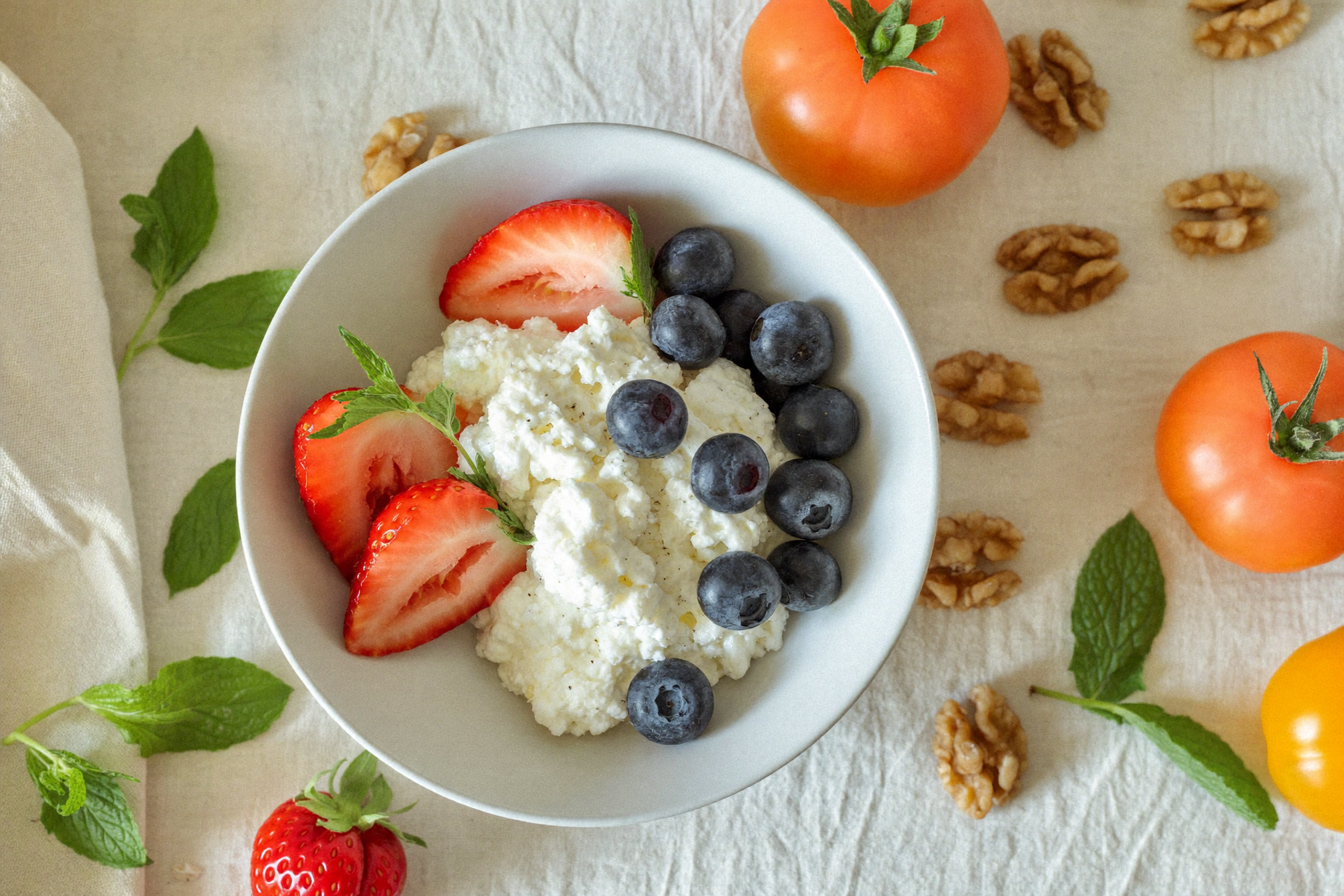 Bowl of creamy cottage cheese with fresh berries and walnuts — a high-protein PCOS-friendly dairy option